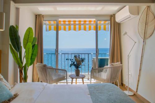 a bedroom with a bed and a view of the ocean at Lemon Beach Boutique Studio in Platja  d'Aro