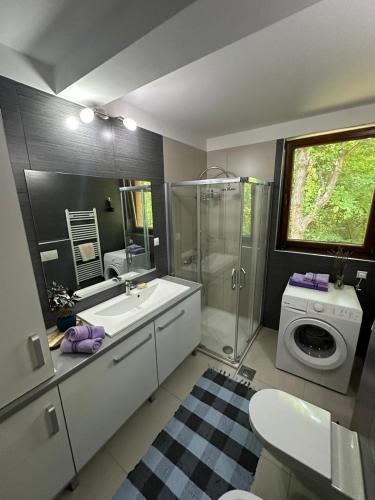 a bathroom with a sink and a washing machine at Plavo oko in Sarajevo