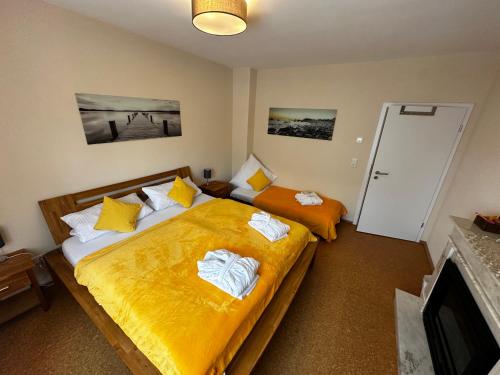 a bedroom with two beds and a tv at CATS Home and Apartment in Bottrop