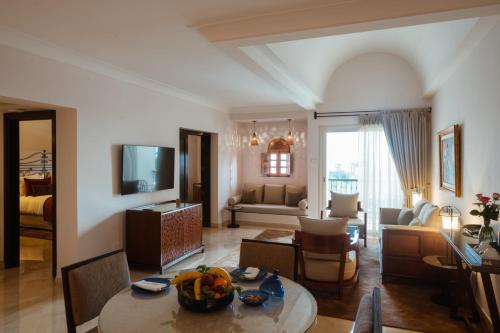 a living room with a dining table and a living room at The Residence Tunis in Gammarth