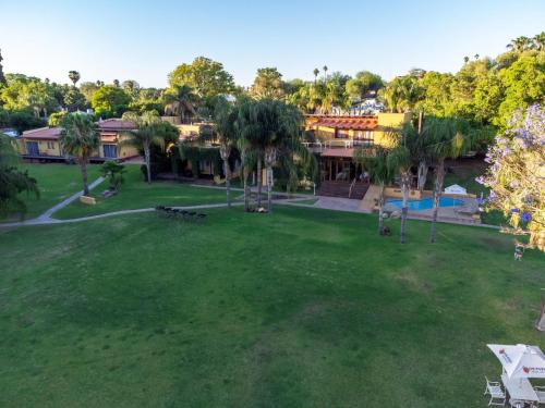 an aerial view of a park with palm trees at Sunriver Kalahari Lodge Riverside stay in Upington in Upington