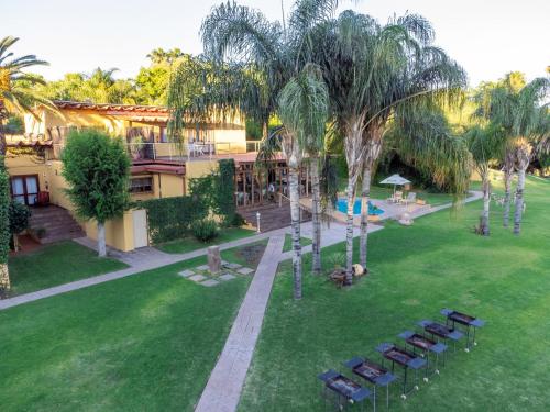 an aerial view of a park with chairs and palm trees at Sunriver Kalahari Lodge Riverside stay in Upington in Upington