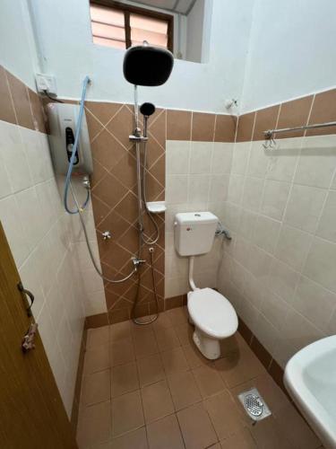 a bathroom with a shower with a toilet and a sink at 7 STAY#1 - 1 Room for 3 Pax at Kuala Berang -Best Travelers Stay in Kuala Berang