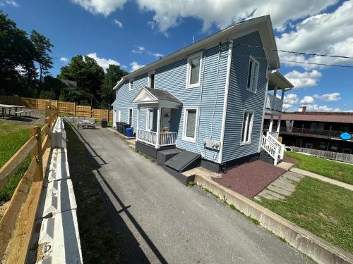 a blue house sitting on the side of a road at 3rd Base Apt 1 All Star Baseball Rentals in Oneonta