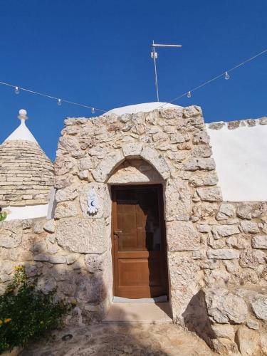 an entrance to a stone building with a wooden door at Trulli Di Spinaruta in Grottaglie