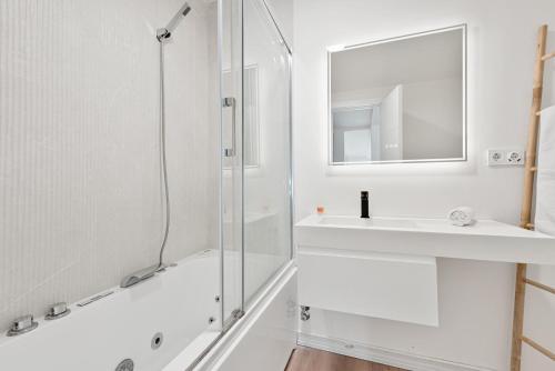 a white bathroom with a shower and a sink at Spiteri 12 by Pineapple Homes in Málaga