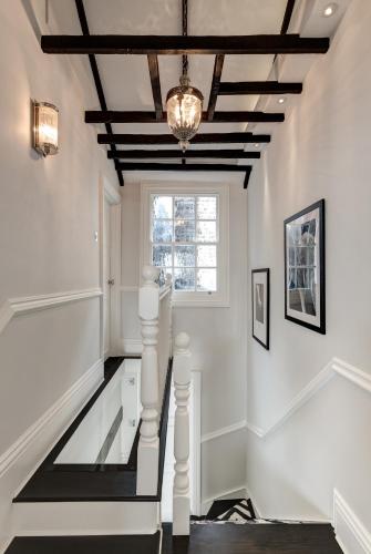a staircase with white walls and a ceiling with a chandelier at Beautiful & Luxurious 3 bed home, with amazing terrace in London