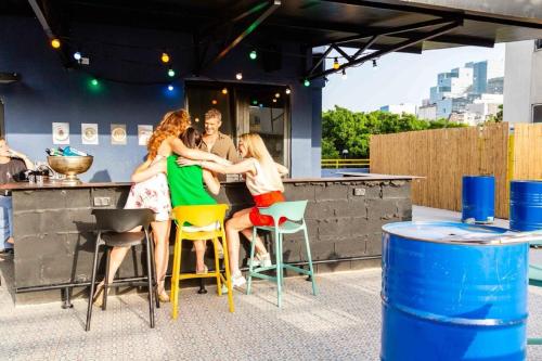 a group of people sitting at a bar at Ninna Palatin in Haifa