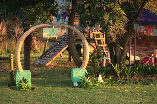 a park with a playground with a slide at The Seed Pod Guesthouse in Modimolle