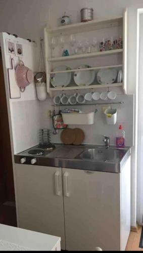 a kitchen with a sink and a counter top at Apartments Ćošković in Podgora