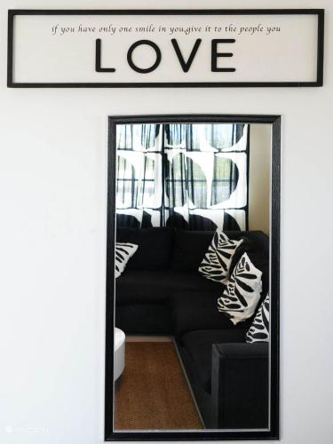 a mirror in a living room with a black couch at 4BlessingsCuracao2 in Willemstad