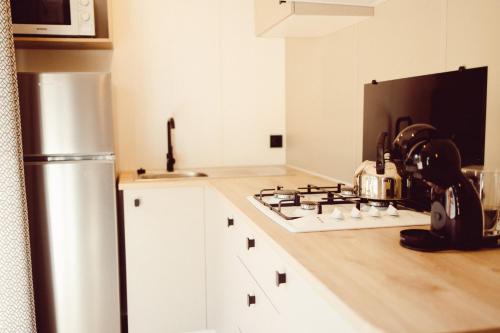 a kitchen with a stove and a refrigerator at Chalet Scharflee in Goebelsmuhle