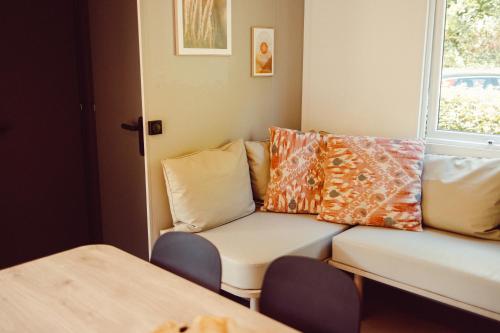 a living room with a couch and a window at Chalet Scharflee in Goebelsmuhle