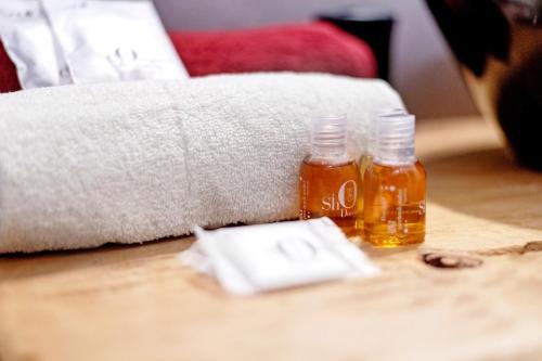 two bottles of honey on a table next to a couch at La Sartoria in Porlezza