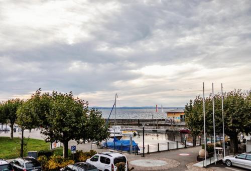 a marina with cars parked in a parking lot at Seehotel Litz in Langenargen