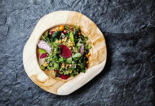 a wooden bowl of food on a table at Seehotel Litz in Langenargen