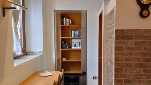 a room with a table and a book shelf at La Vecchia Posta in Anzano del Parco