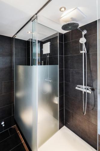 a shower with a glass door in a bathroom at Seehotel Litz in Langenargen