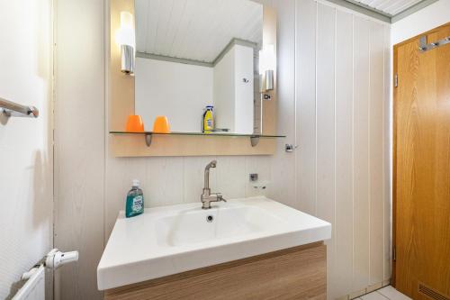 a bathroom with a white sink and a mirror at Atlanta Pur in Pellworm