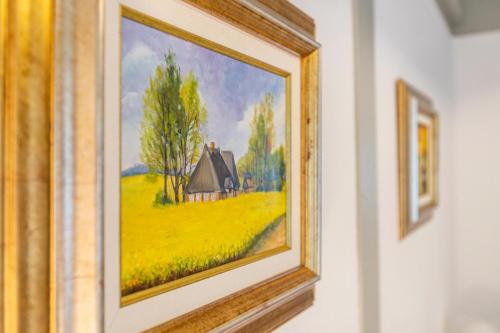 a painting of a farm on a wall at Atlanta Pur in Pellworm