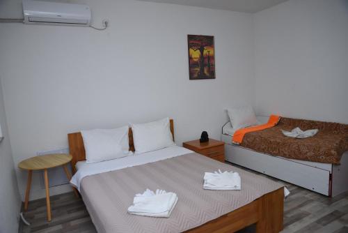 a small bedroom with a bed and a chair at Rooms Filip in Bitola