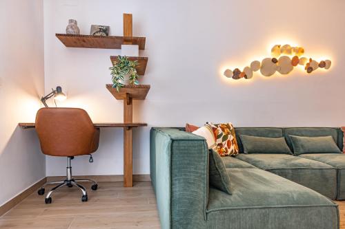 a living room with a couch and a desk at K-ROOTS by Nuka Homes in Jávea