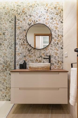 a bathroom with a sink and a mirror at K-ROOTS by Nuka Homes in Jávea