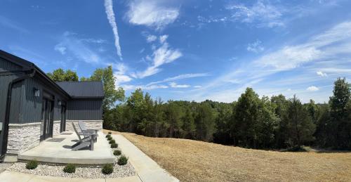a bench sitting on a sidewalk next to a building at 100 Acre Relaxing Retreat Near Ark- The Cabin in Williamstown