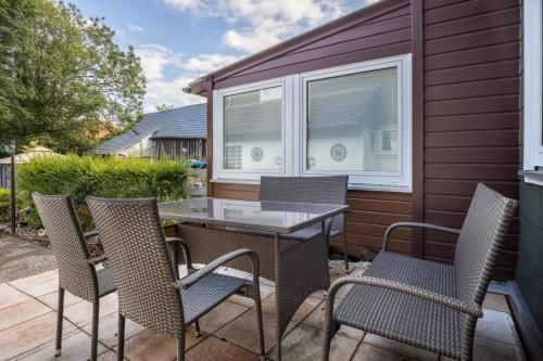 a patio with chairs and a table and a window at Bergmannsruh in Clausthal-Zellerfeld