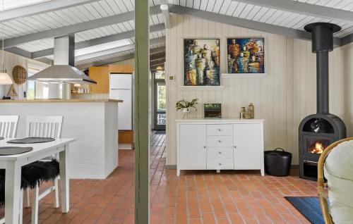 a kitchen with a table and a stove at 3 Bedroom Beautiful Home In Vinderup in Vinderup