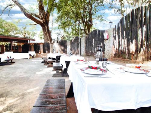 a group of tables with plates of food on them at Hotel 247 @ White River in White River