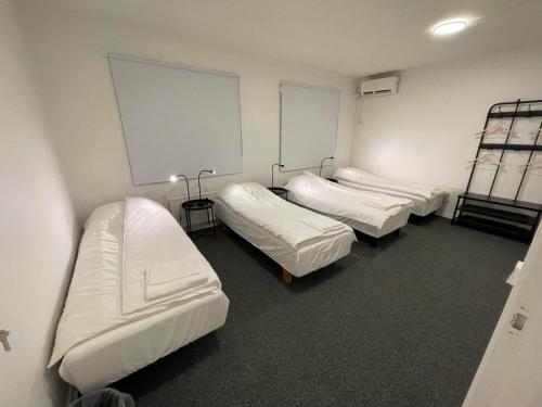 a room with four beds in a room at Office Motel in Gothenburg