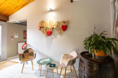 a room with chairs and hearts on the wall at Relais Vosgien - Hôtel Restaurant "la Table de Sophia" in Saint-Pierremont