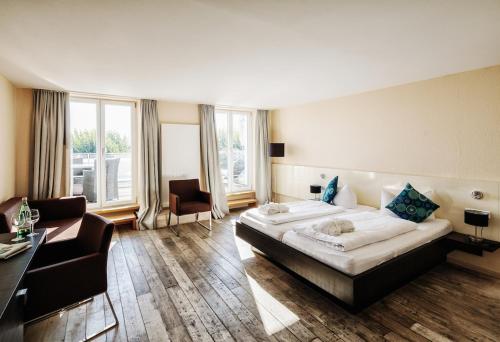 a hotel room with a large bed and a couch at Seehotel Litz in Langenargen