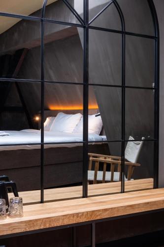 a black bunk bed with white pillows in a room at City Center Lodge Utrecht in Utrecht