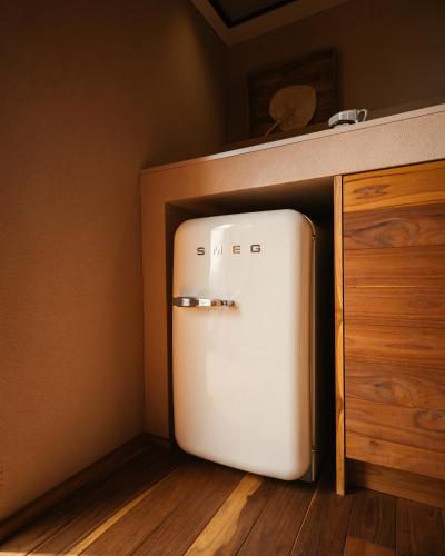 a refrigerator in a kitchen next to a cabinet at Vinha by NHôme in Ponte de Lima
