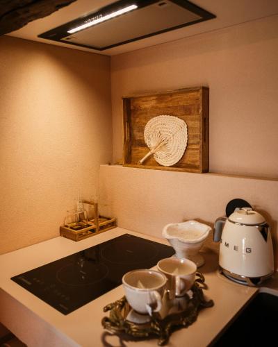 a kitchen counter with a tea set on a stove at Vinha by NHôme in Ponte de Lima
