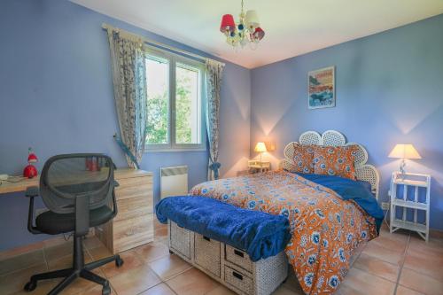 - une chambre bleue avec un lit, un bureau et une chaise dans l'établissement Lou Poutou du Levant, à Gramat