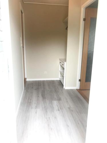 an empty room with a closet and a dresser at Villa Holmen 2 - Ground floor apartment in Balestrand