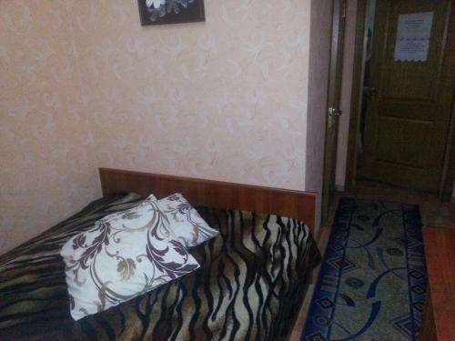 a bedroom with a bed with a pillow on it at ABBA Hotel in Kyiv