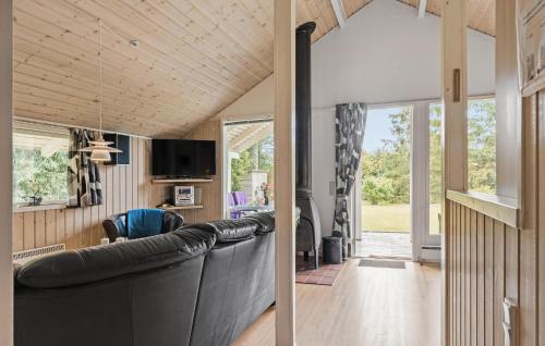 a living room with a large black leather couch at Cozy Home In Fårvang With Wifi in Fårvang