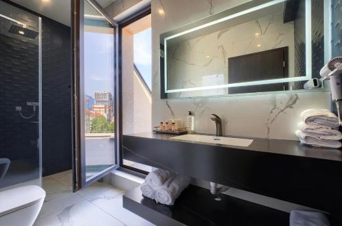 a bathroom with a sink and a mirror at Aurora Sofia in Sofia