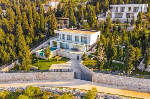 an aerial view of a house in the mountains at Villa Serenity Luxury Lakeside Manor in Široka