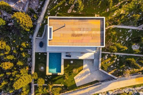 an overhead view of a building with a pool at Villa Serenity Luxury Lakeside Manor in Široka