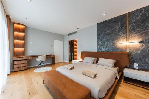 a bedroom with a large bed and a couch at Villa Serenity Luxury Lakeside Manor in Široka