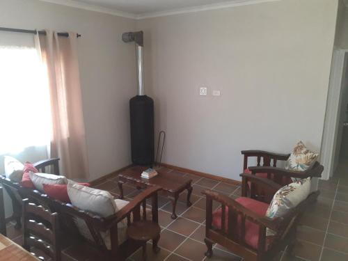 a living room with chairs and a table at Kleinfontein in Clanwilliam