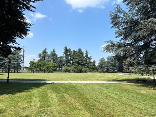 a park with a bench in the middle of a field at Casa Mirè in Savigliano
