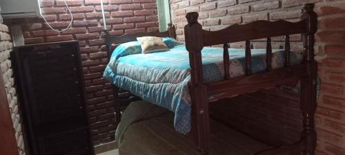 a bedroom with a bed in a brick wall at Apartamentos Agosto in Nueva Galia