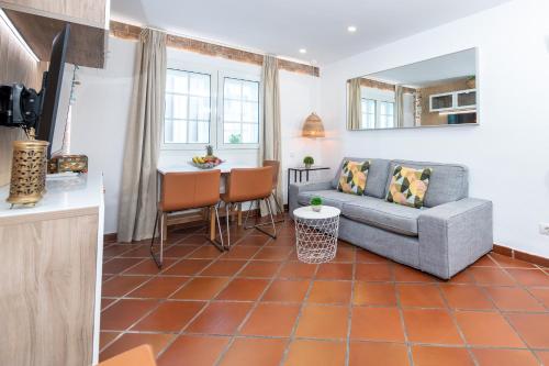 a living room with a couch and a table at Calas Beach Corralejo in Corralejo