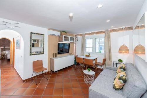 a living room with a couch and a table at Calas Beach Corralejo in Corralejo